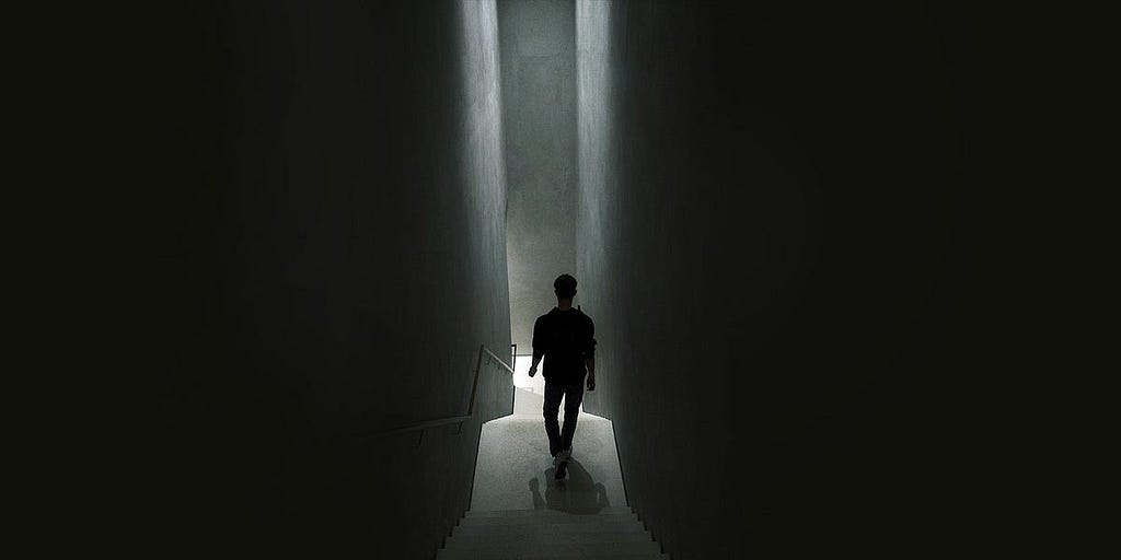A person going down dark stairs