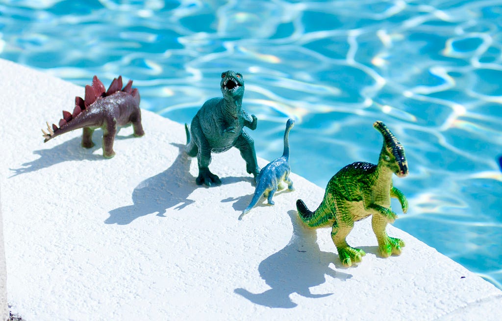 Dinosaur toys by the pool