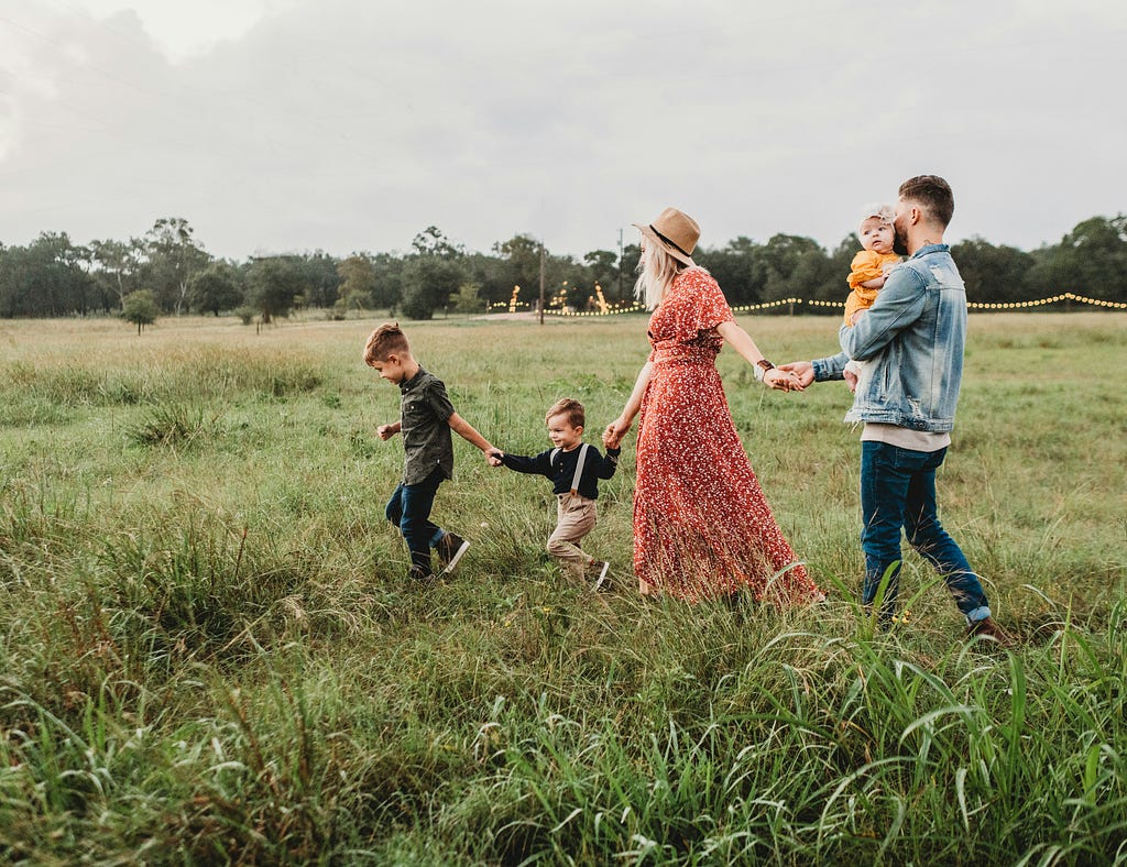 A family joyfully walking together in nature.