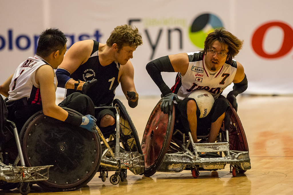 Male para-athletes in a wheelchair designed for playing volleyball. Source: https://commons.wikimedia.org/wiki/File:2014_IWRF