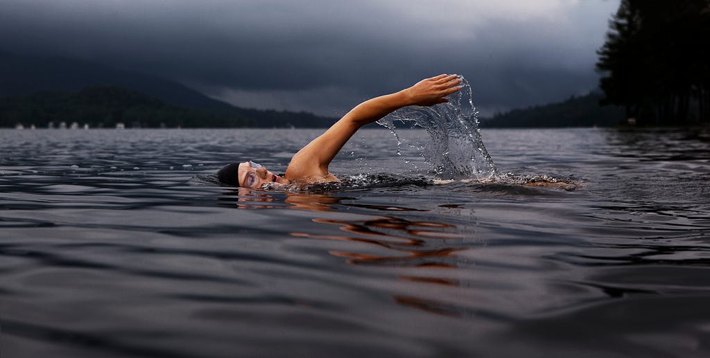 A guy swimming on a lake
