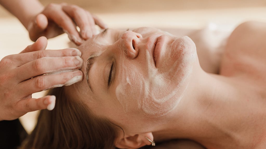 A person getting a facial cleanse.