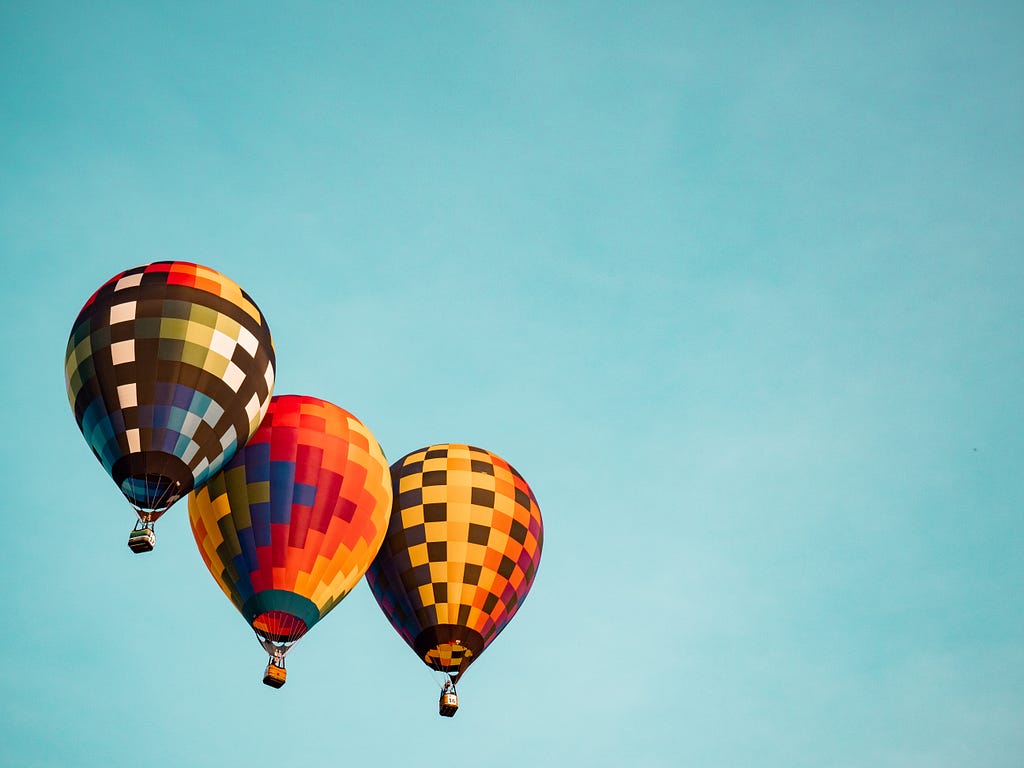 three hot air balloons in the sky