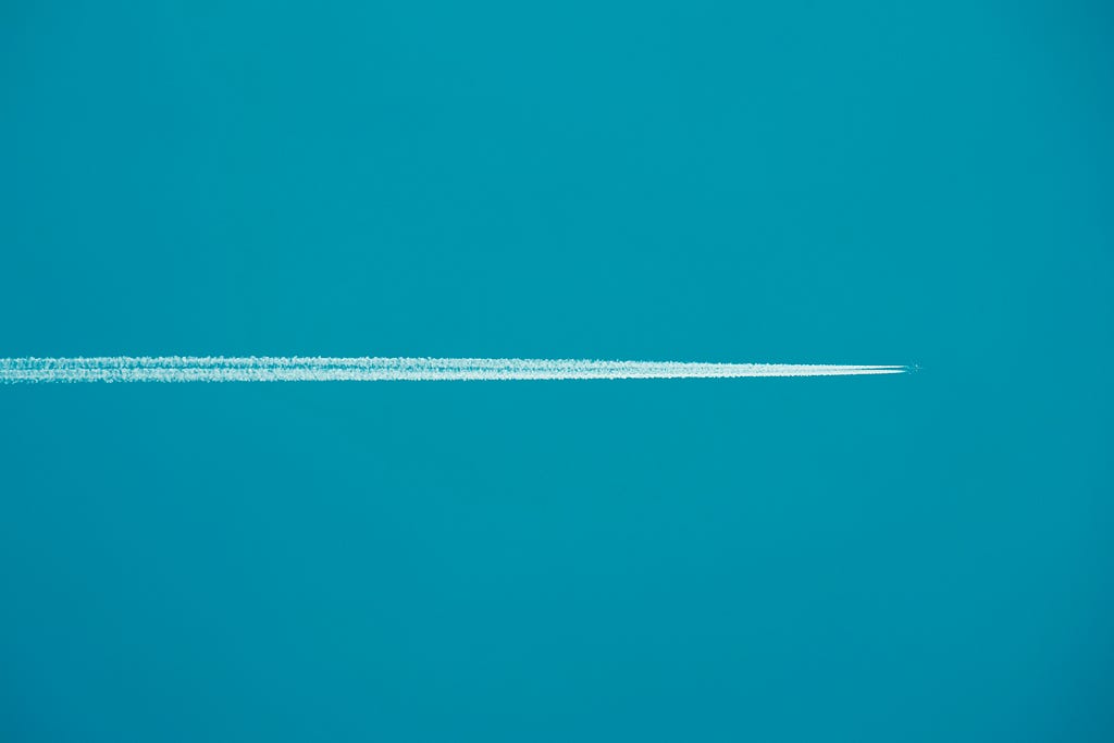 plane going through a blue azure sky