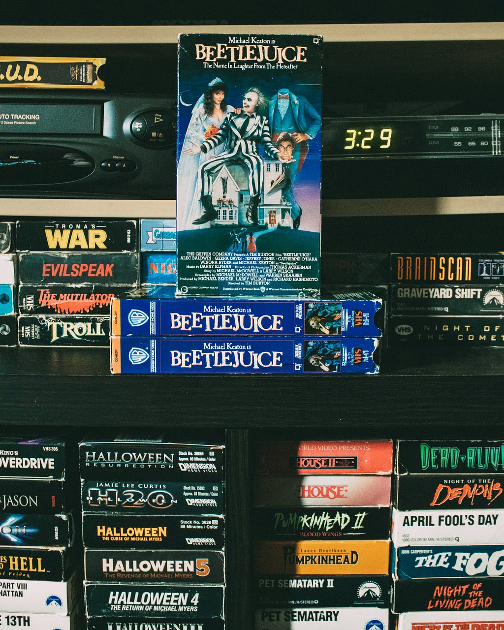 A photo with a variety of VHS scary and horror movies, including Warner Brothers’ Beetlejuice (1988) starring Michael Keaton and directed by Tim Burton — photo by Bruno Guerrero