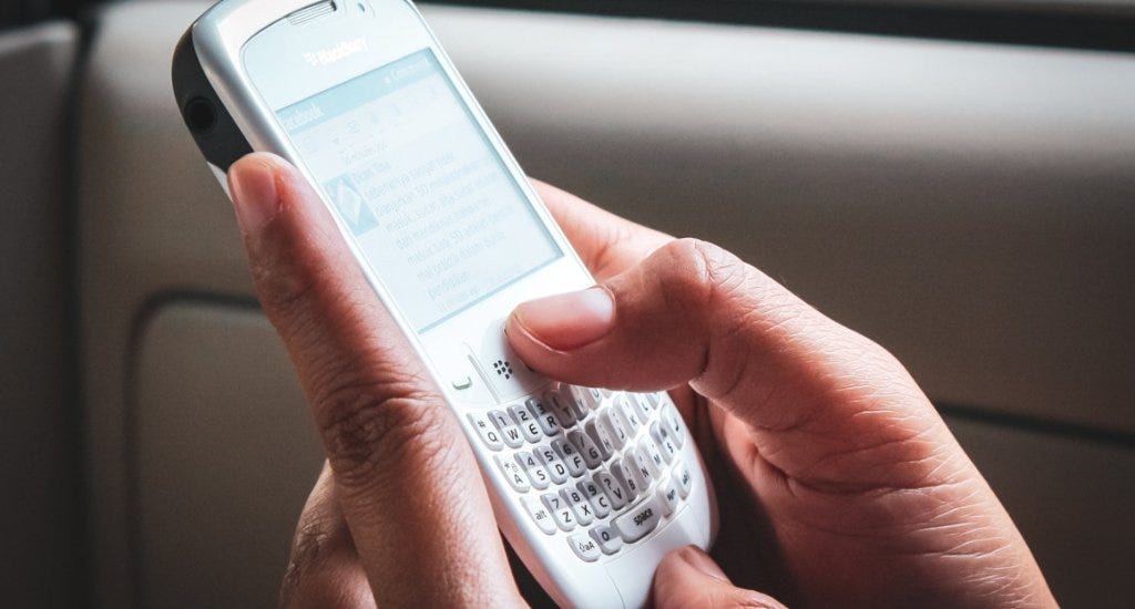 Entrepreneur texting on a Blackberry phone