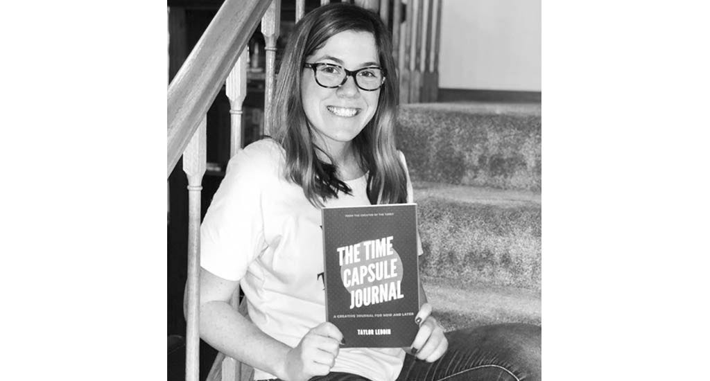 Taylor Leddin holding copy of The Time Capsule Journal