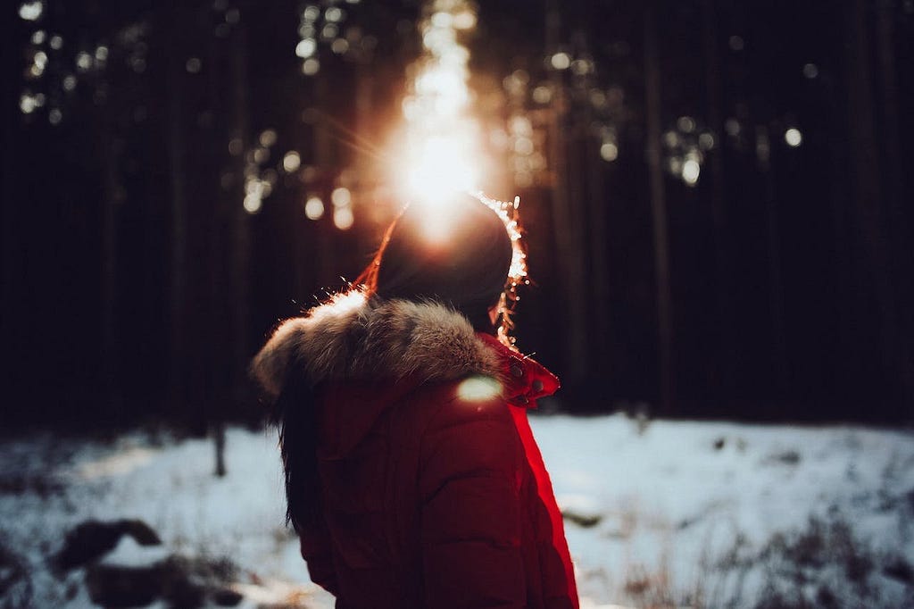 Woman in red coat in snowy backdrop