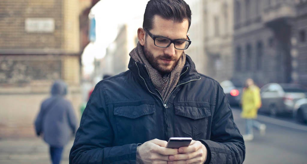 Business owner checking February 2020 career horoscope on phone