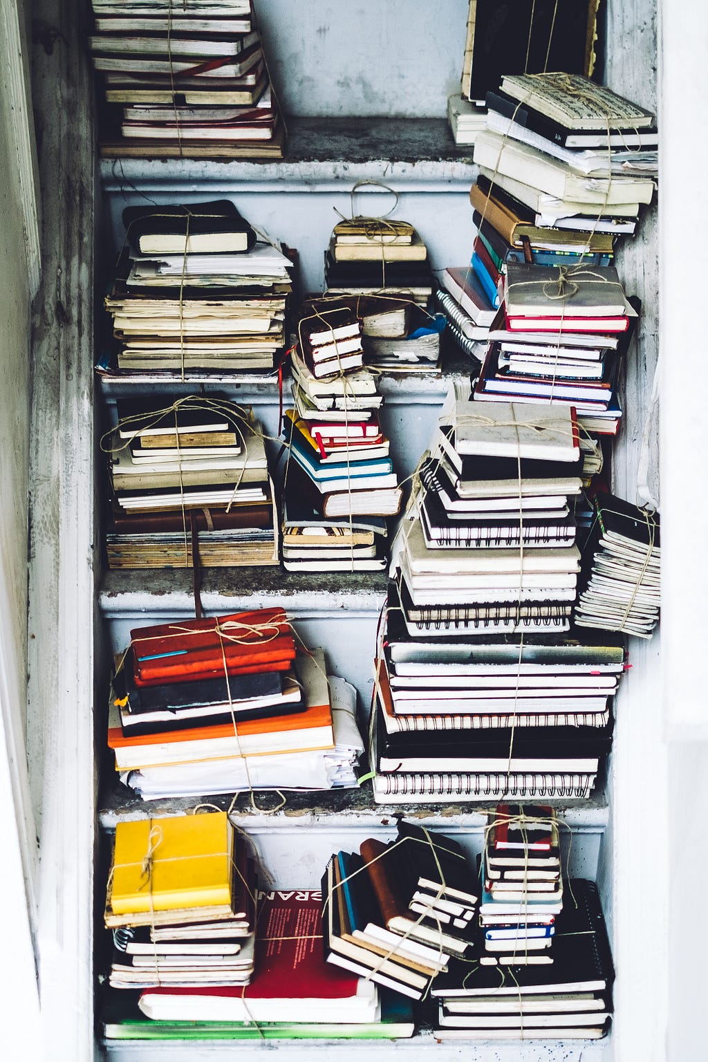 a stack of journals and diaries