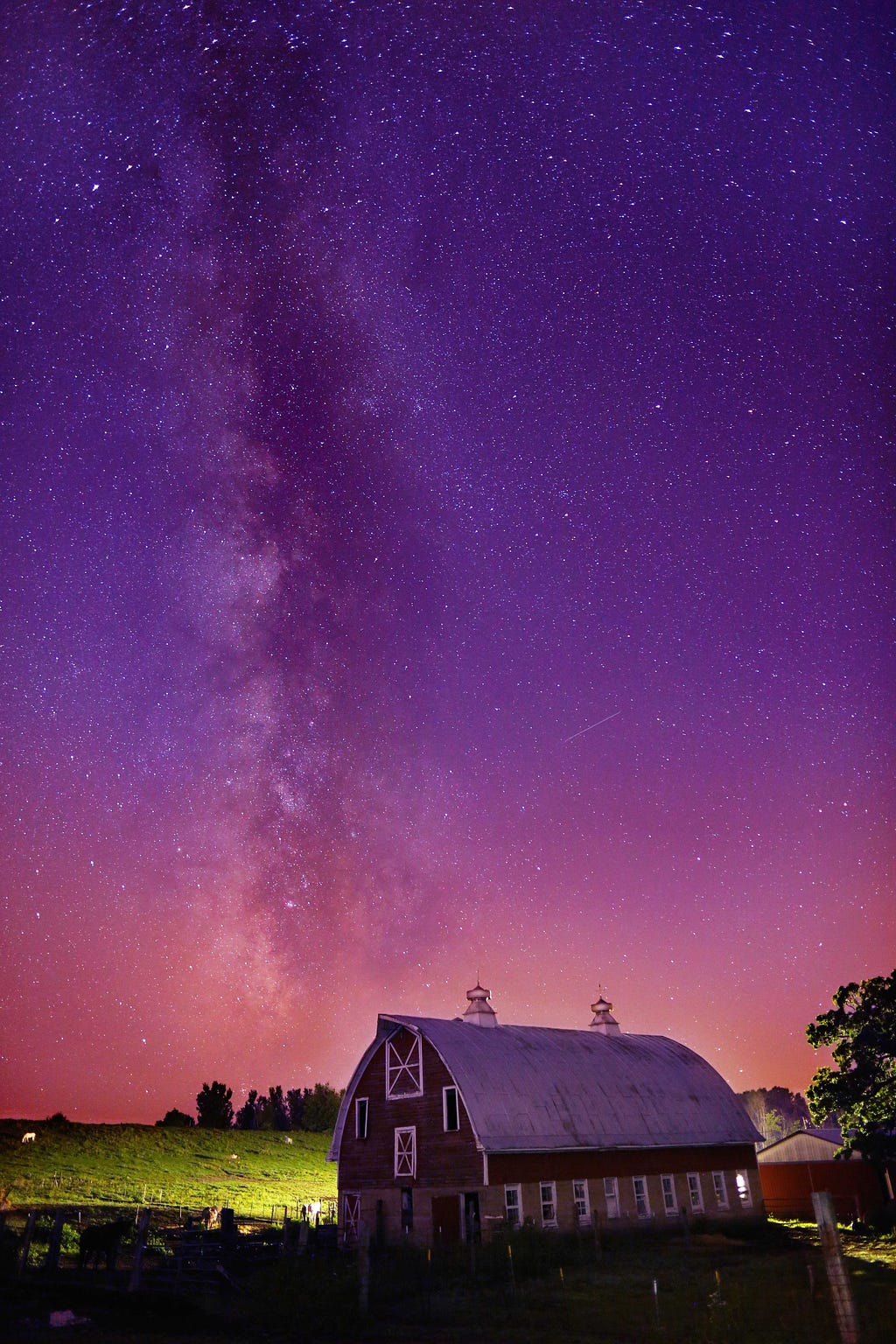 Milky way stretching over an old barn in the country