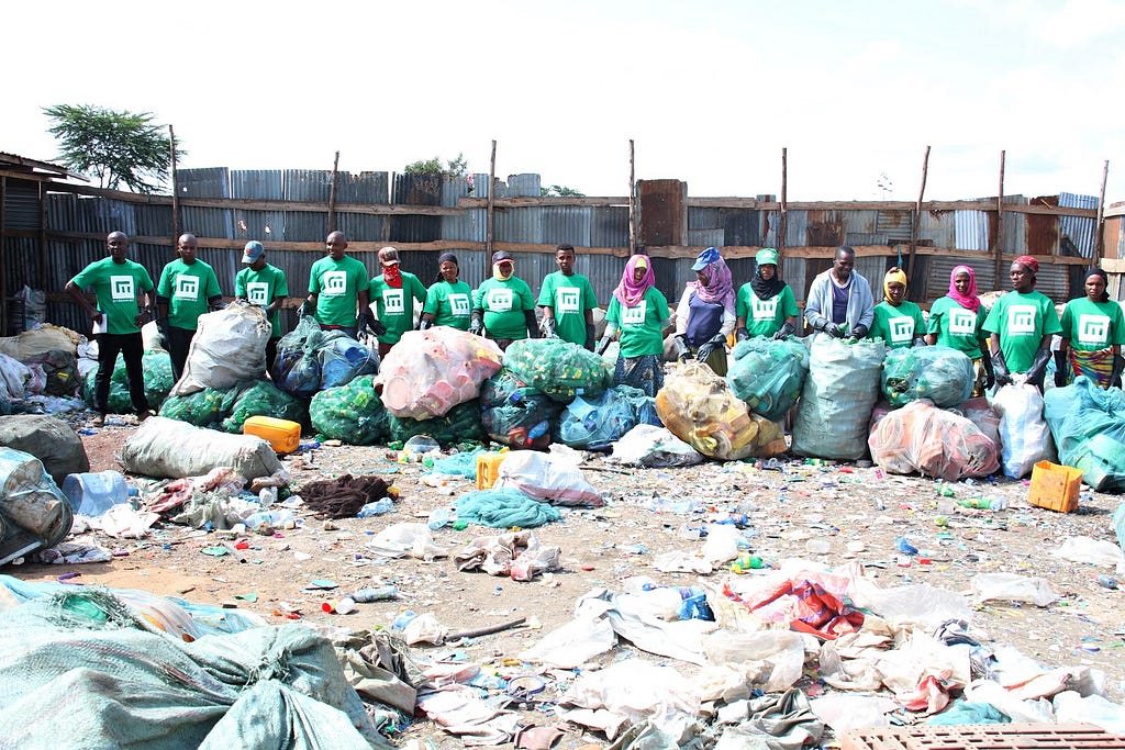 A handful of the fantastic waste collectors from our clean-up in Arusha with the waste collected during the clean-up.