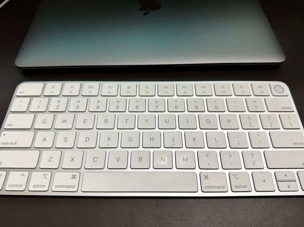 Magic Keyboard next to MacBook Air M1