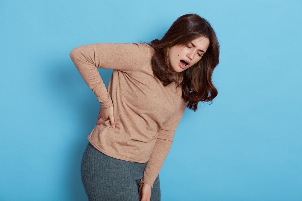 An image of a woman experiencing back pain.