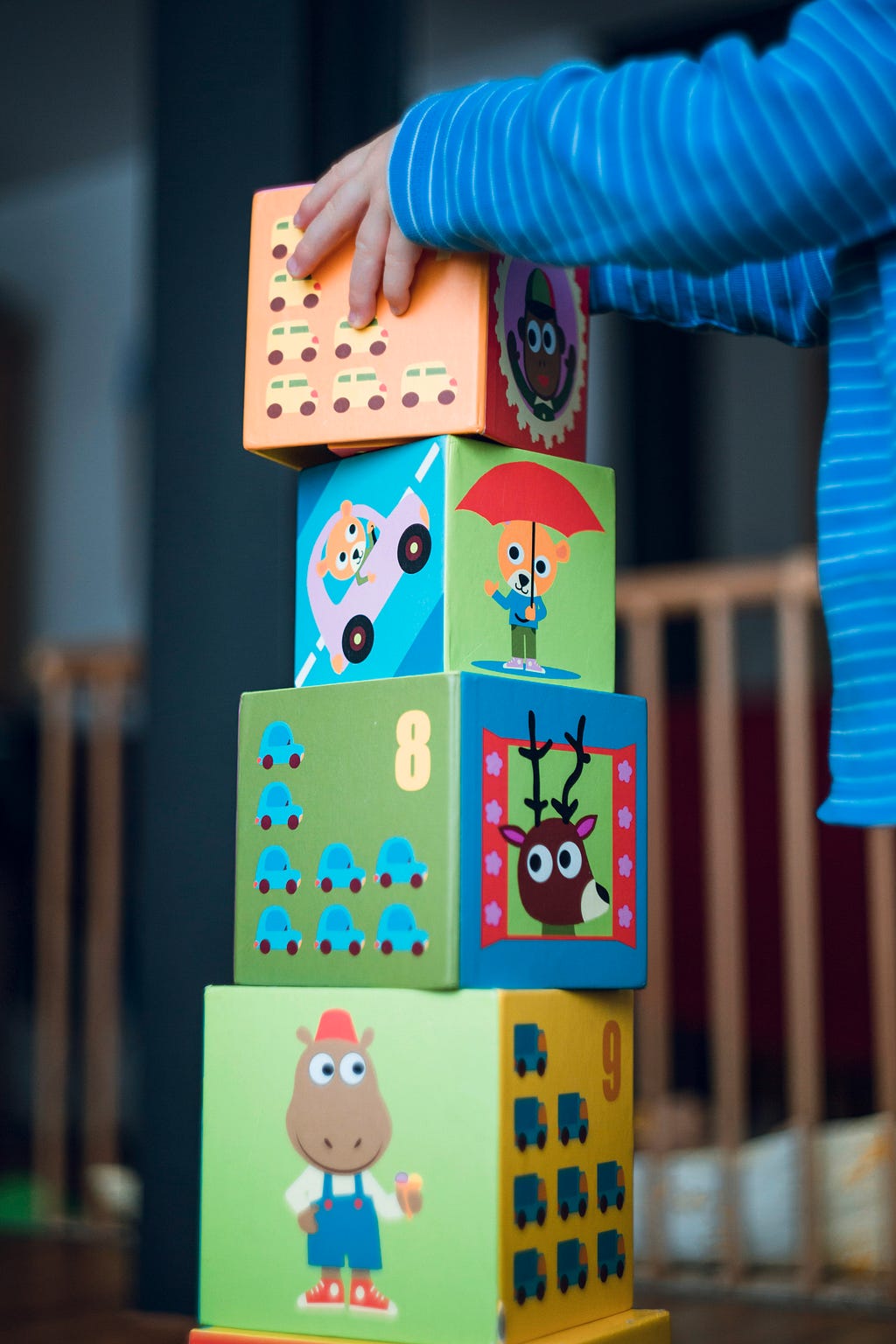 A child building a fort out of building blocks engaging in creative play and imaginative thinking.