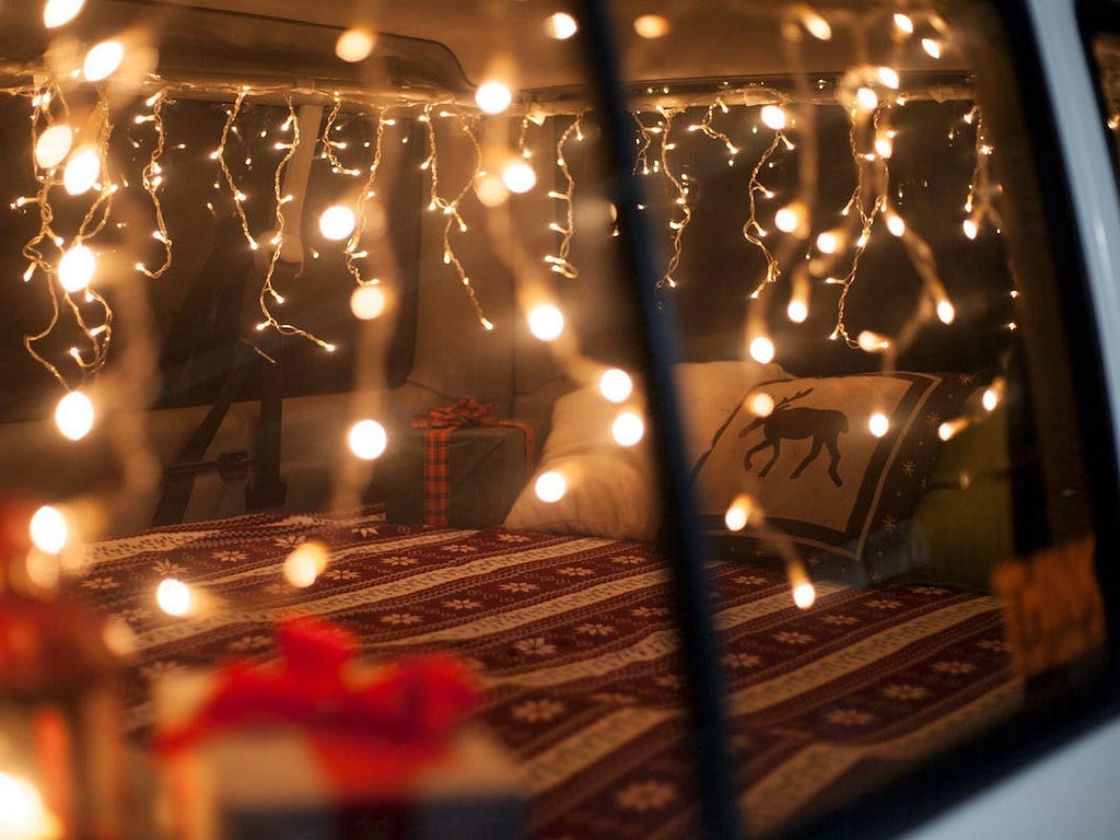 A Christmas-themed throw pillow inside a van.