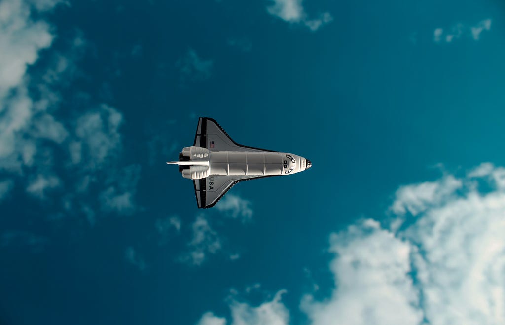 A space shuttle against the bright blue sky