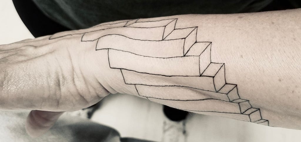 A tattoo wrapped around the wrist that is of a visual representation of harmony.