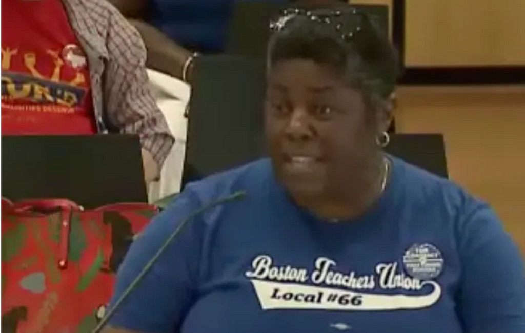 Photo of Curley teacher Kafunda Banks speaking to the School Committee June 5