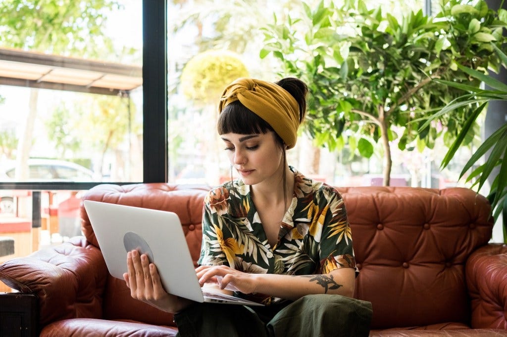 Woman working on laptop on the couch