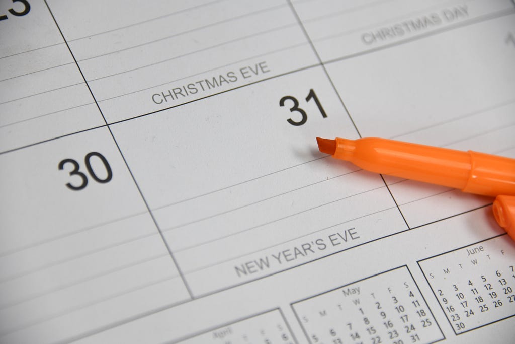Marker hovering over December 31 on a calendar — a popular go-to deadline for risk registers.