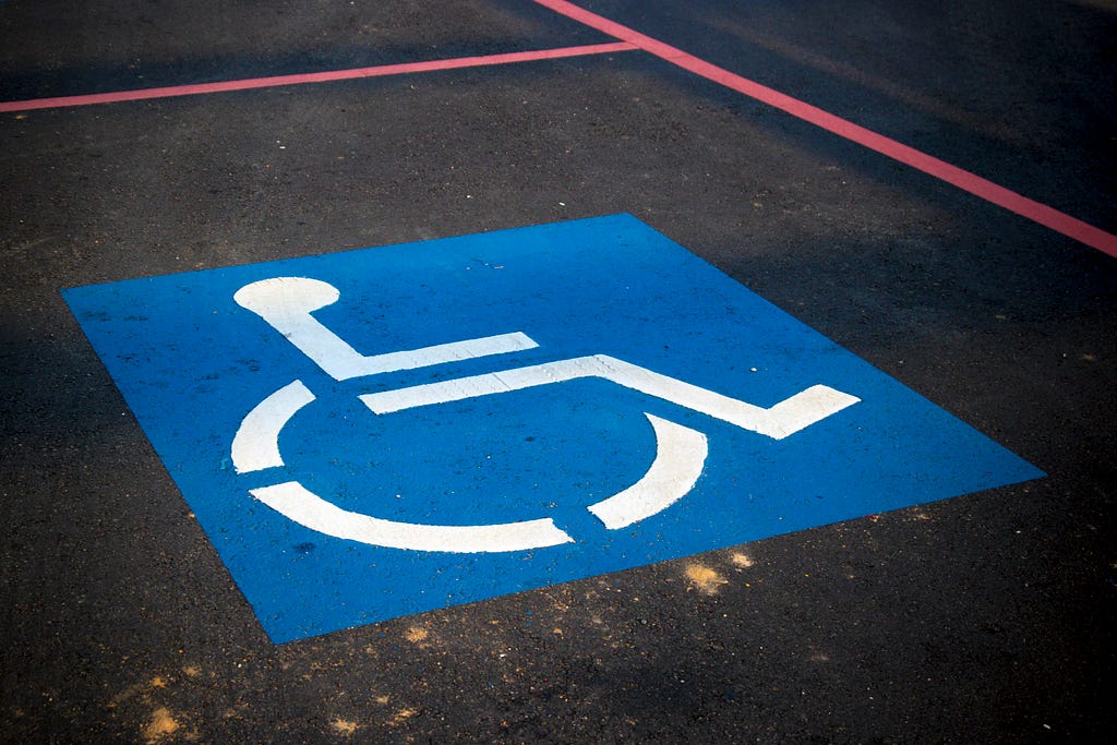 A parking space with a wheelchair marker to represent accessibility