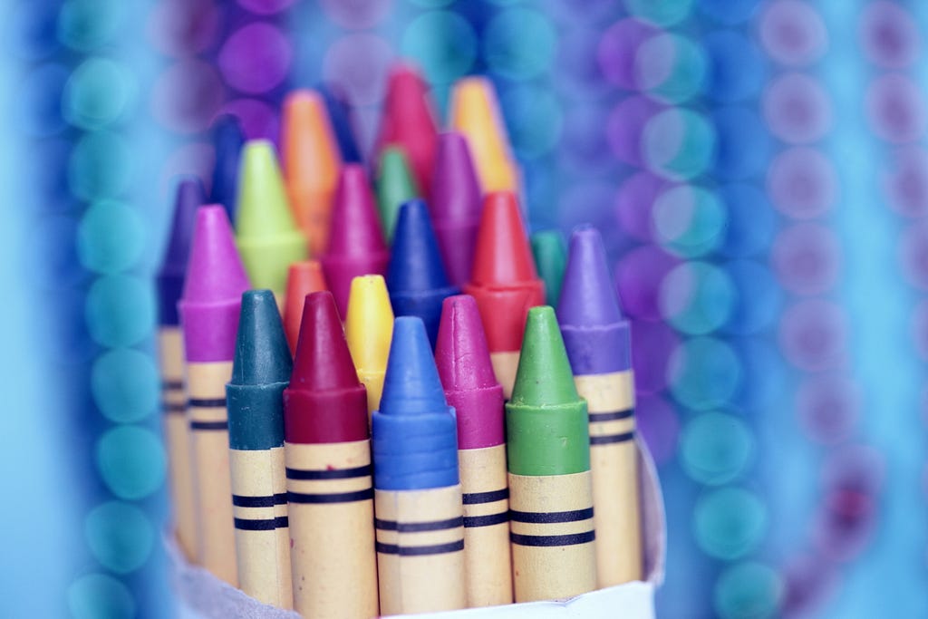 Around 20 crayons wrapped in a piece of paper with a bokeh background effect