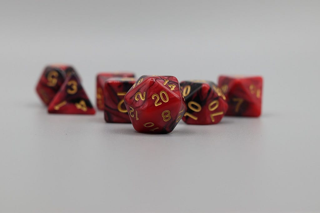 A set of red tabletop gaming dice on a white background.