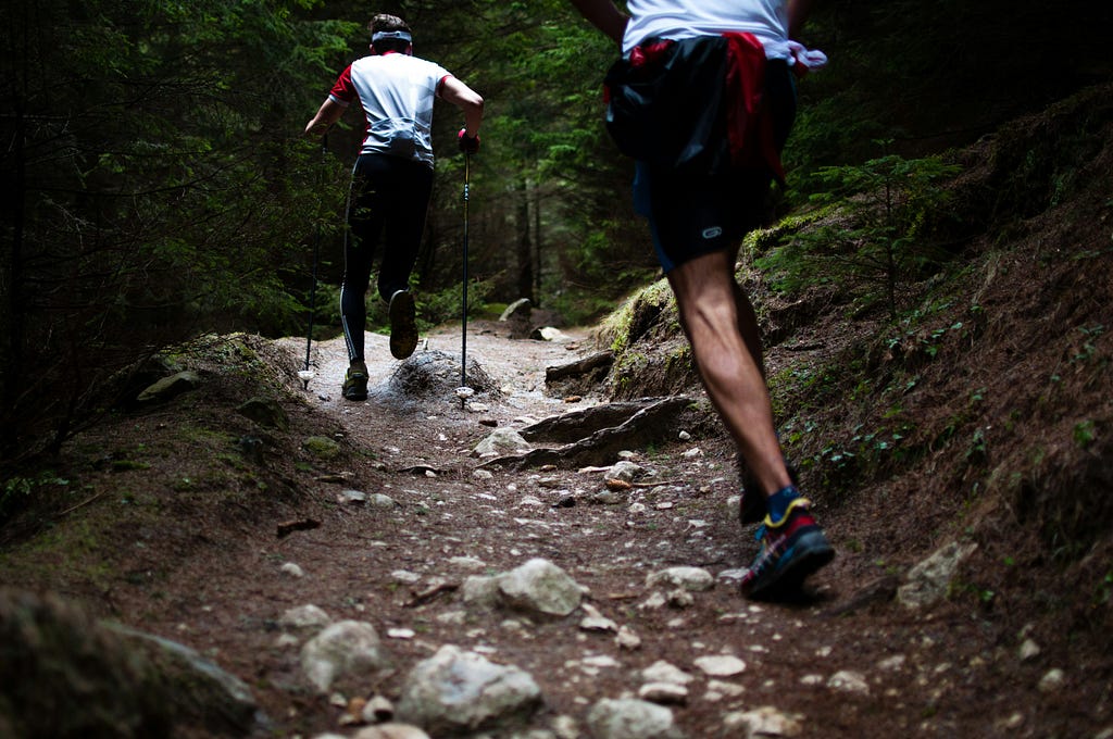 runners heading up a steep hill