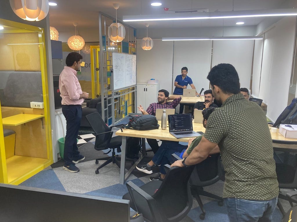 Pictured: VP of Engineering, Deepak Angrula and various engineers including Kushagra chat at our Nirvana Bangalore office