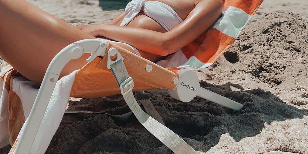 Woman reclings on Sunflow Beach Chair