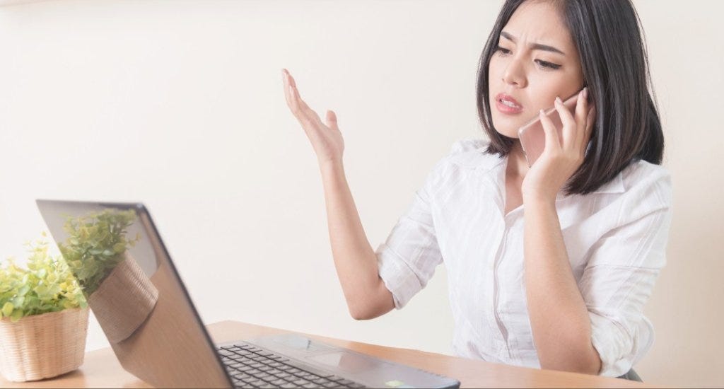 Woman looks frustrated while talking on the phone