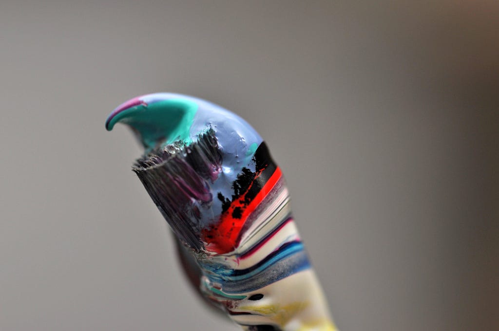 Paintbrush with multiple colors of thick paint
