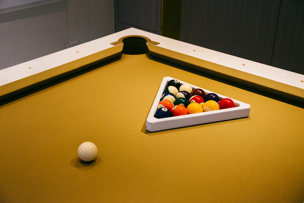 An American set-up of 8-Ball with a sort of sandy-coloured baize.