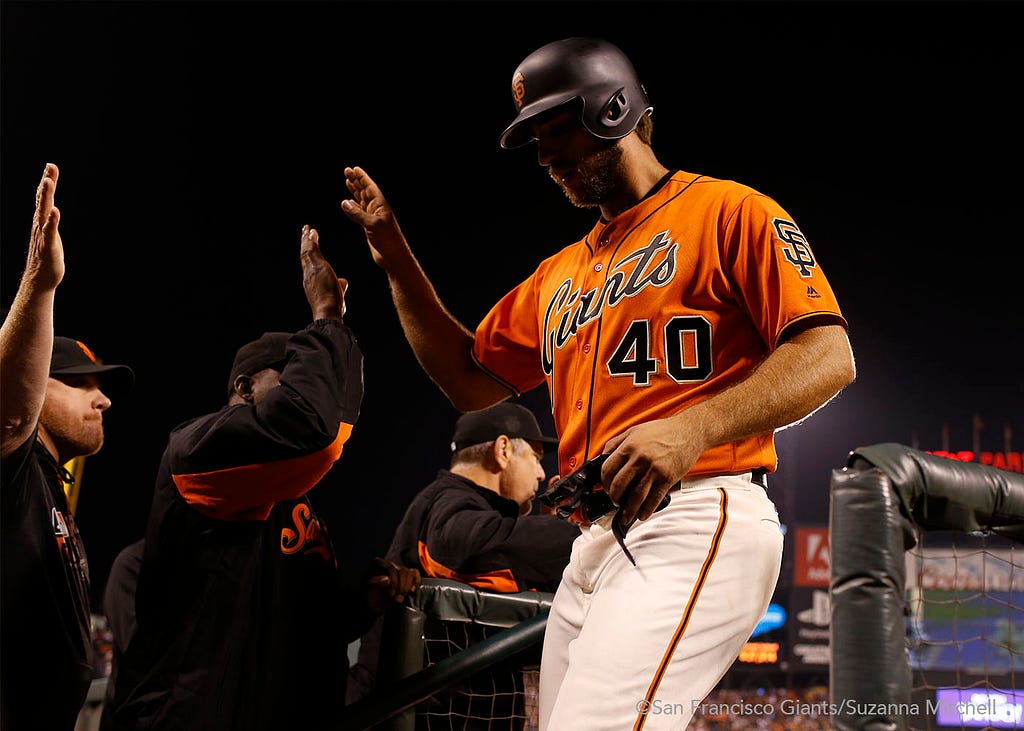 Madison Bumgarner celebrates after scoring on a home run hit by Brandon Belt in the sixth inning.