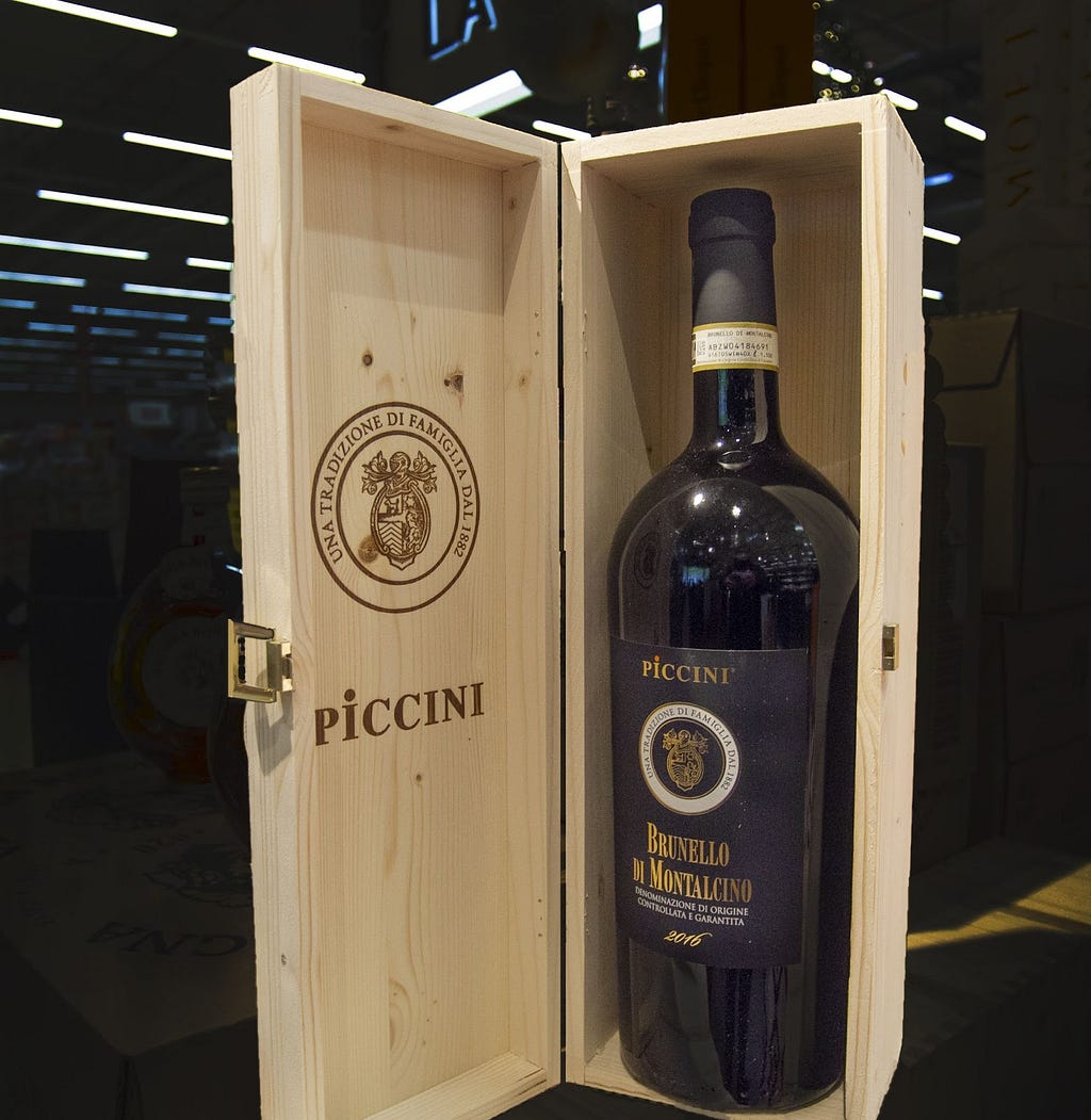 A magnum bottle in a wooden wine case