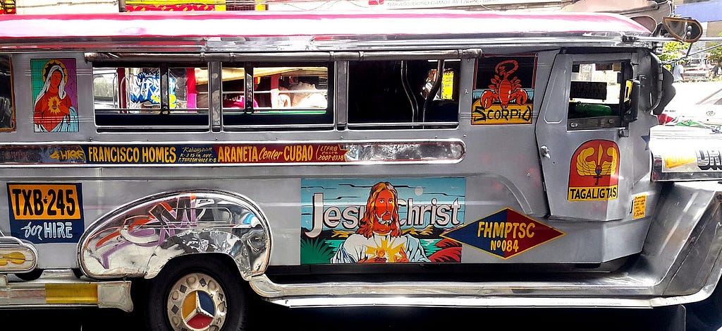 A jeepney with flat colour blocked religious art