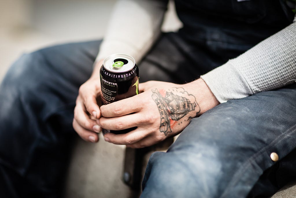 Man holding a monster energy drink