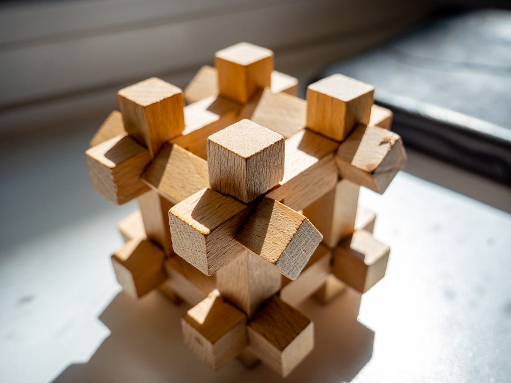 a wooden puzzle linked together to form a standing square