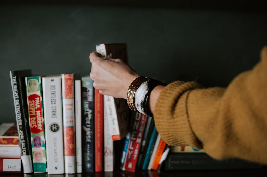 Taking a book of a shelf