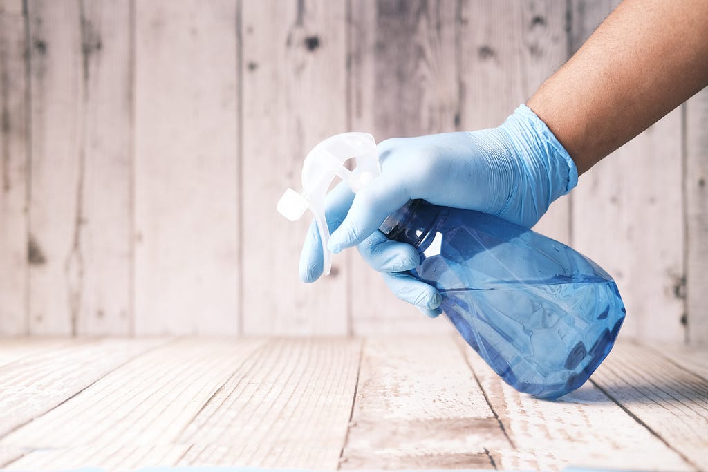 Spray bottle being used for cleaning representing cleaning strategies for those with inattentive ADHD