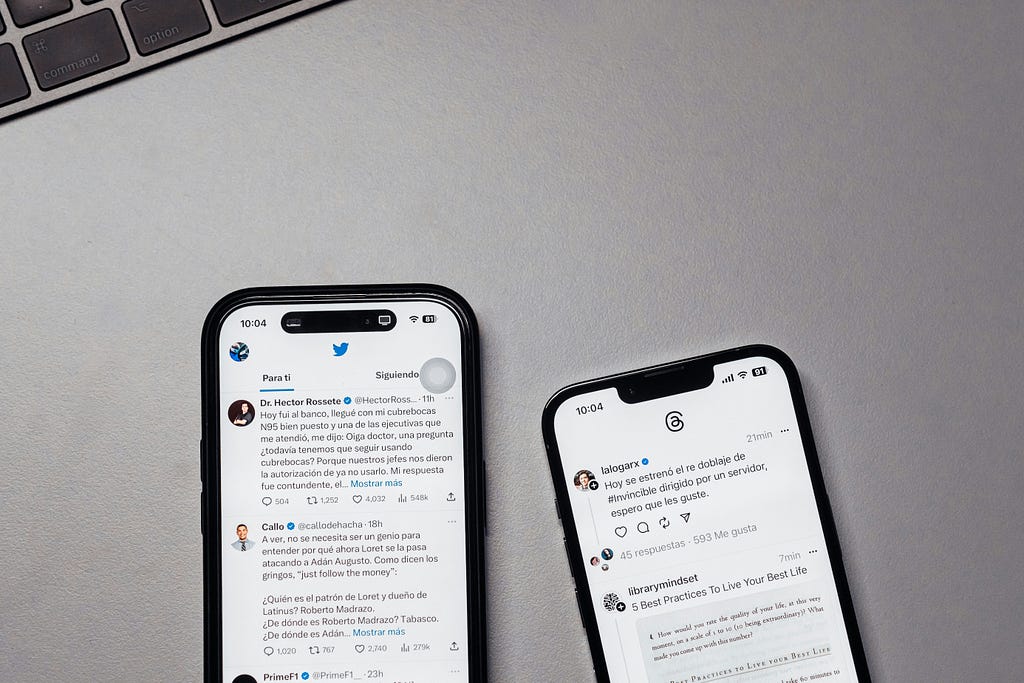 Two phones displaying posts on the Threads, the Meta microblogging app feed