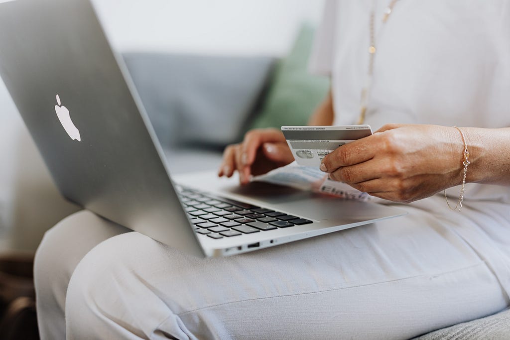 person holding a card making an online payment.