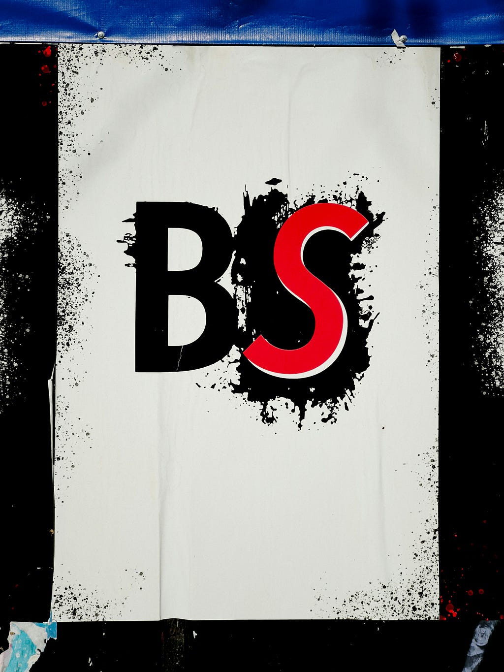 The letters “BS” spray painted on a white background