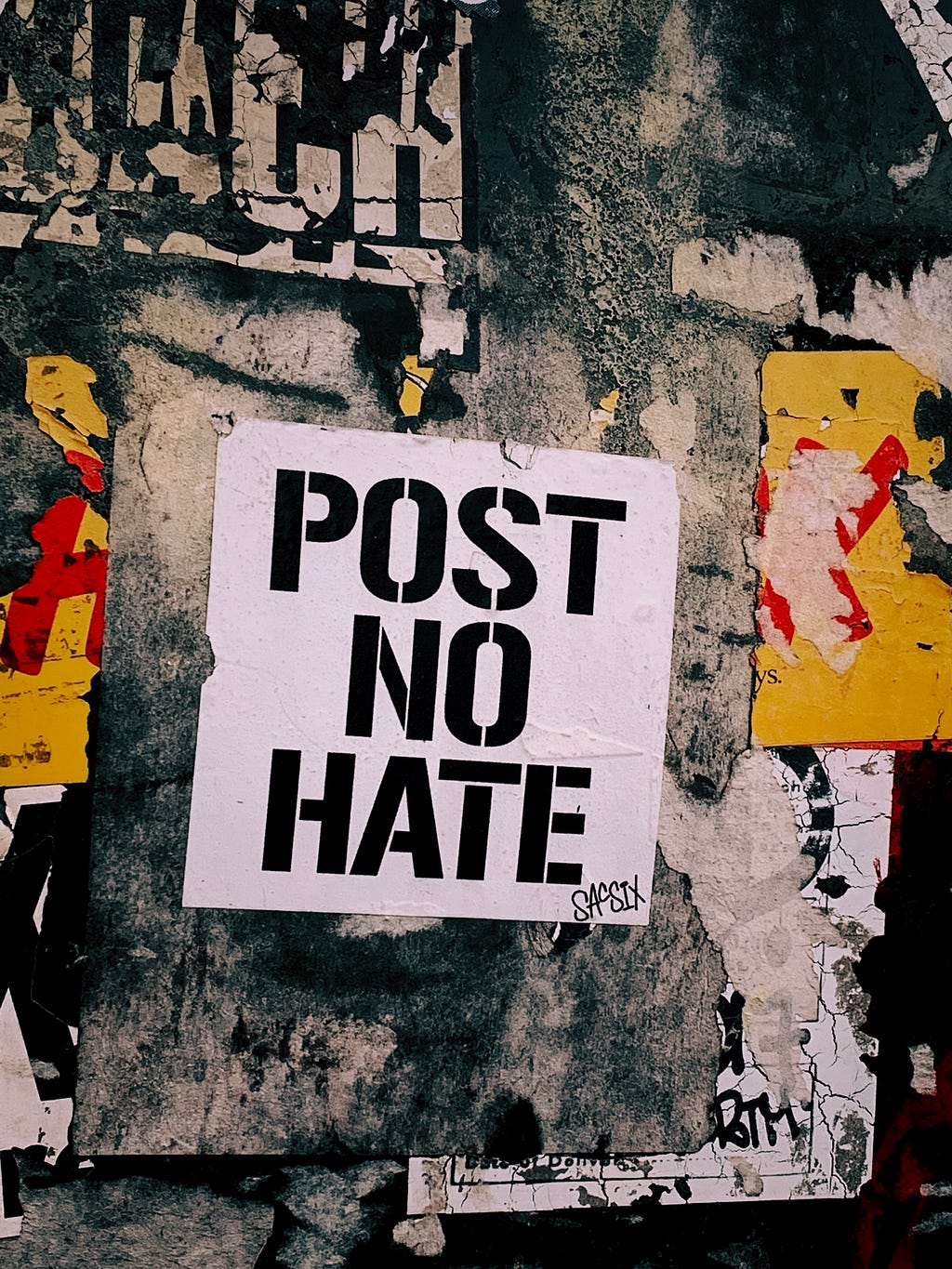 White paper with the words “Post No Hate” written.