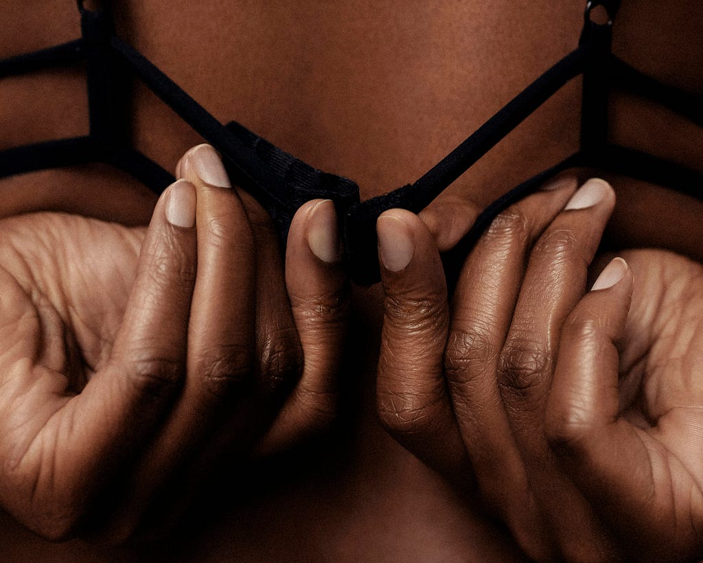 hands unfastening a bra from behind