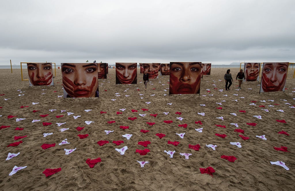 Members of the NGO Rio de Paz hold a demonstration against violence against women, displaying some 420 panties and portraits of bloodstained women, in Copacabana, Rio de Janeiro on June 6, 2016.   According to the NGO, some 50,000 women each year are sexually assaulted in Brazil.  / AFP / VANDERLEI ALMEIDA        (Photo credit should read VANDERLEI ALMEIDA/AFP/Getty Images)