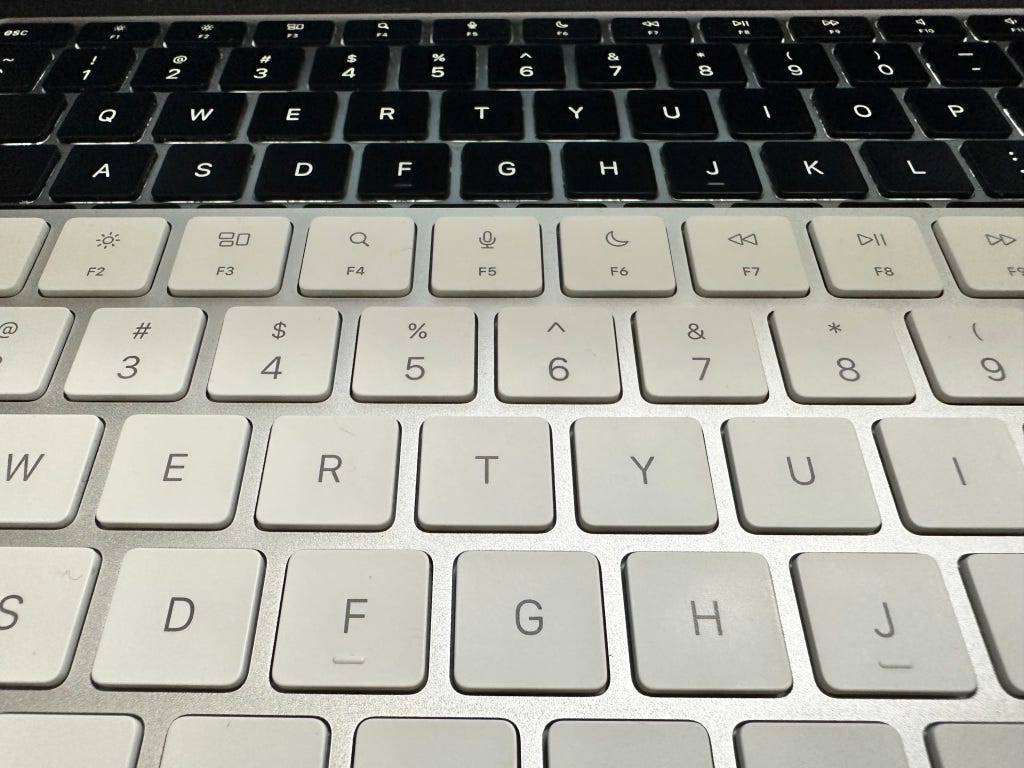 Magic Keyboard on top of MacBook air for comparision of keys