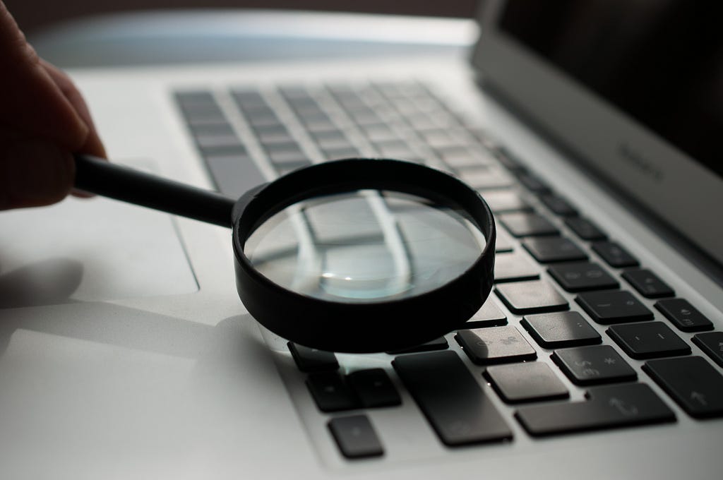 Looking at a computer through a magnifying glass