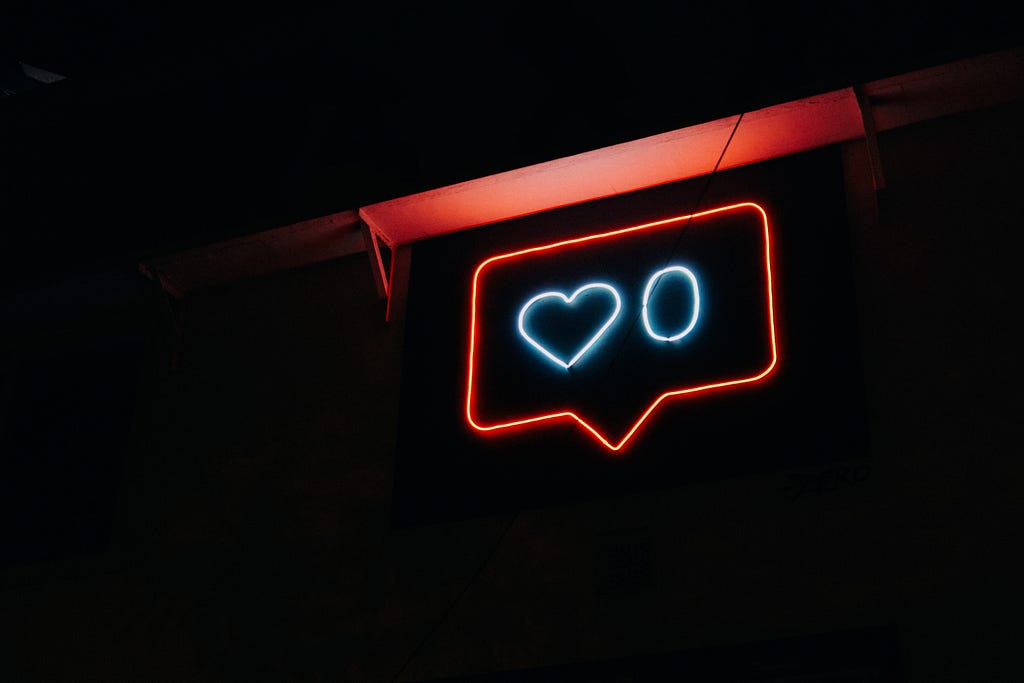 A neon sign displays a “zero” inside the Instagram heart icon